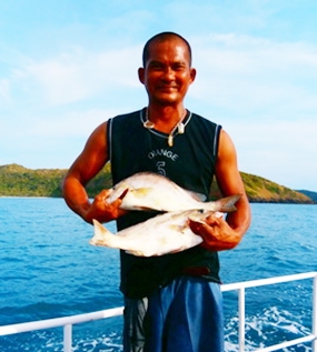 The Captain holds up two greys caught on June 2.
